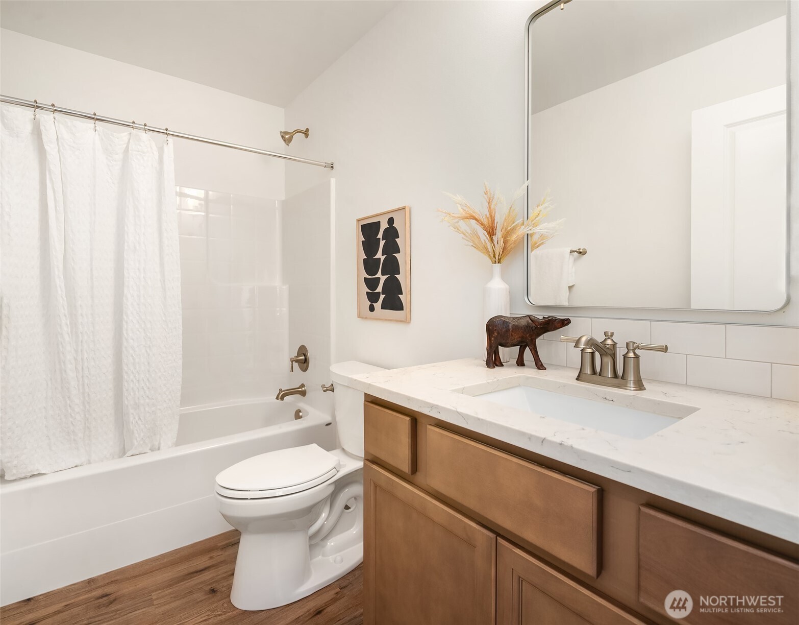 2401 East 16th Street Bremerton, WA 98310 - Photo 16 of 30 a bathroom with a granite countertop sink a toilet and a bathtub