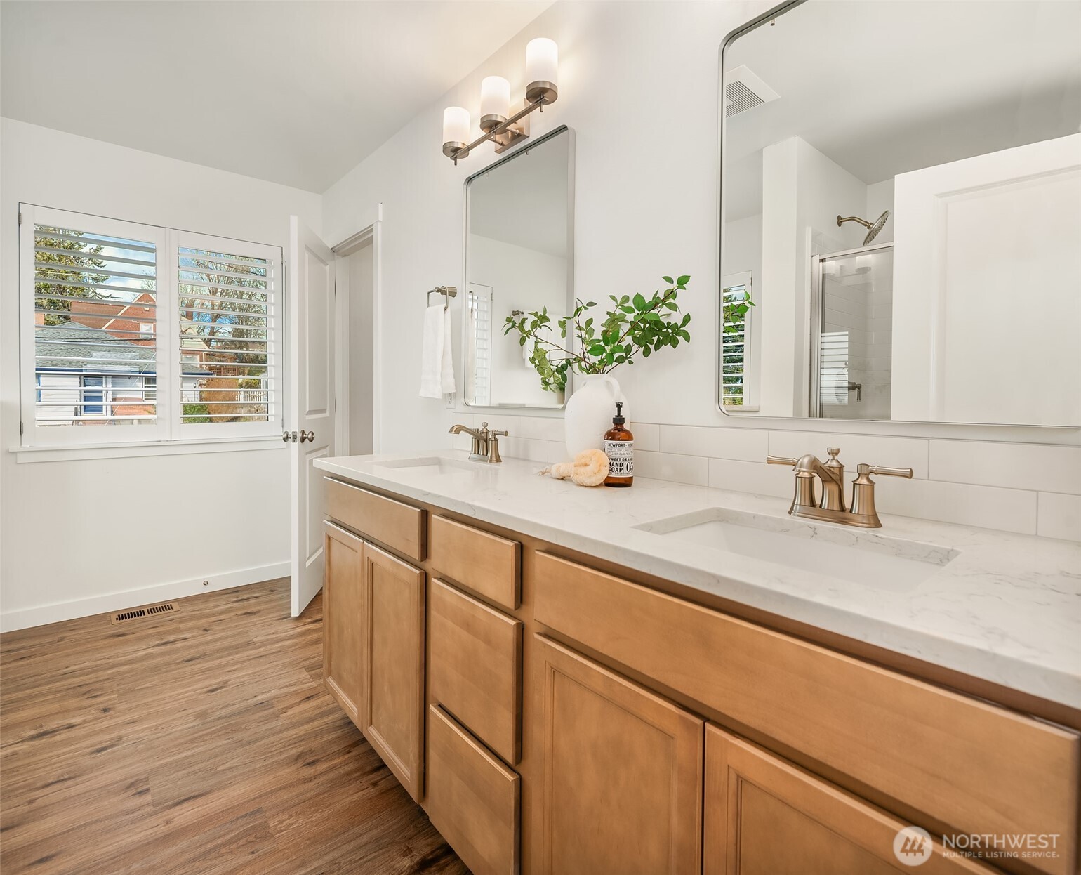 2401 East 16th Street Bremerton, WA 98310 - Photo 19 of 30 a bathroom with a sink and a large mirror