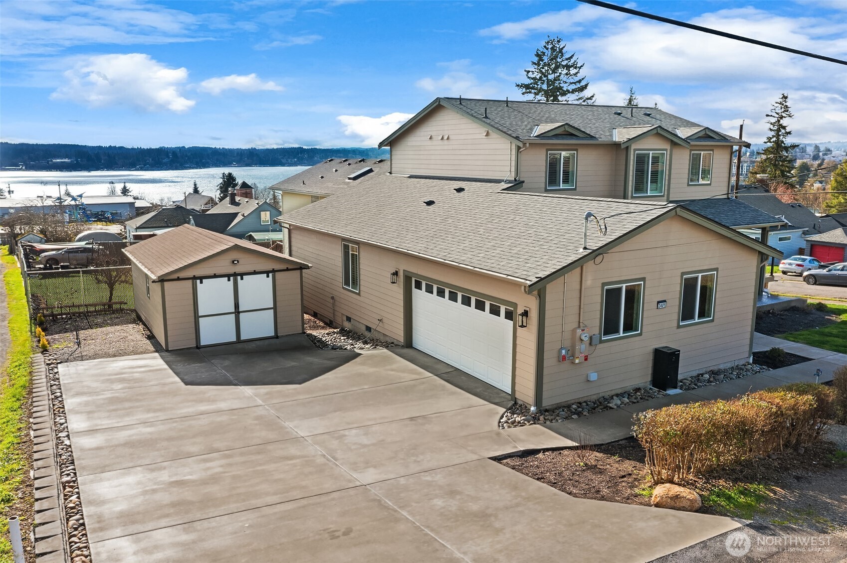 2401 East 16th Street Bremerton, WA 98310 - Photo 25 of 30 a view of a white house with large windows and a table