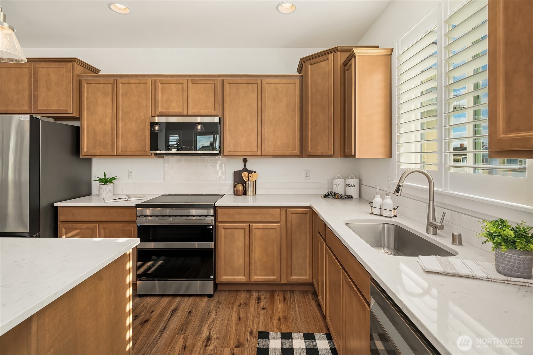 2401 East 16th Street Bremerton, WA 98310 - Photo 6 of 30 a kitchen with stainless steel appliances a stove sink microwave and cabinets