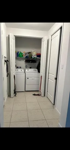 a kitchen with a refrigerator and a stove