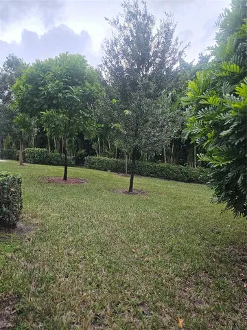 a swimming pool with outdoor seating and yard