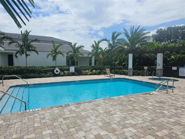 a view of a swimming pool with a patio
