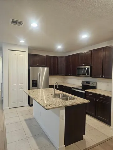 a kitchen with stainless steel appliances granite countertop a sink counter space and cabinets