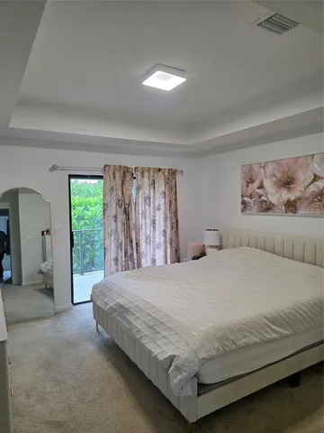 a bedroom with a large bed and a large window