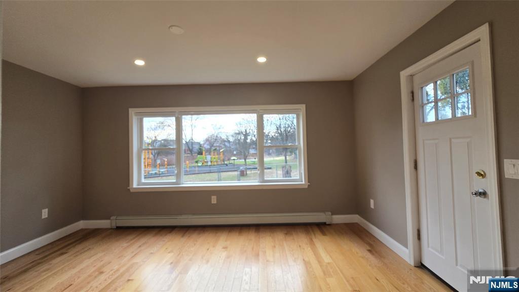2-72 Saddle River Road Fair Lawn, NJ 07410 - Photo 12 of 33 a view of an empty room with wooden floor and a window