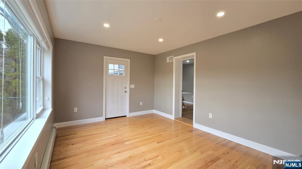 2-72 Saddle River Road Fair Lawn, NJ 07410 - Photo 13 of 33 an empty room with wooden floor and windows