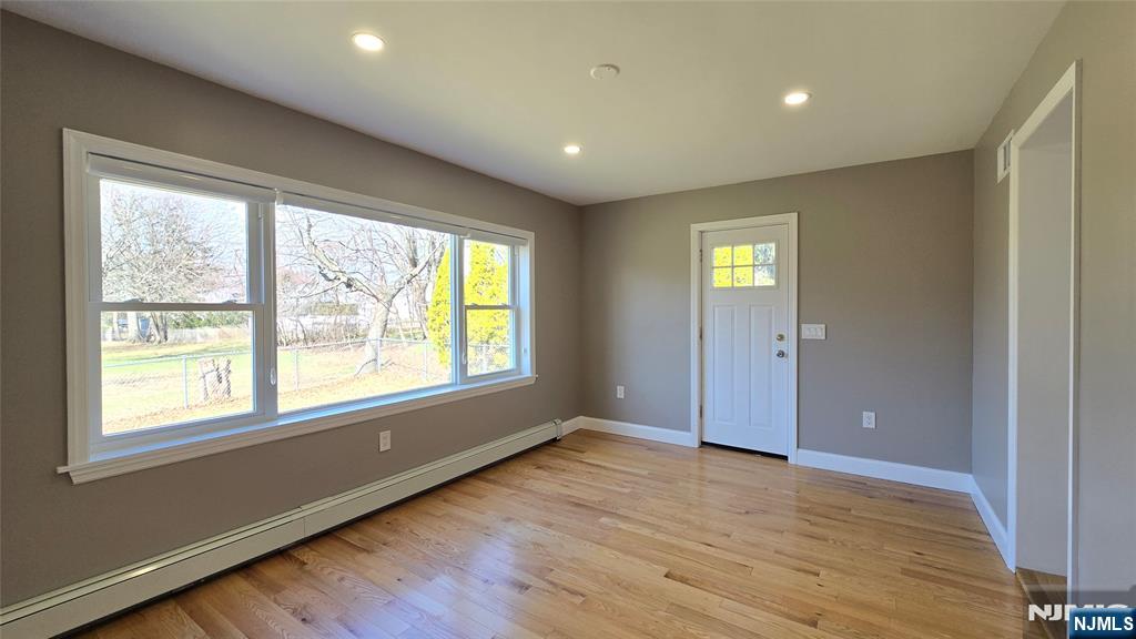2-72 Saddle River Road Fair Lawn, NJ 07410 - Photo 14 of 33 a view of an empty room with wooden floor and a window
