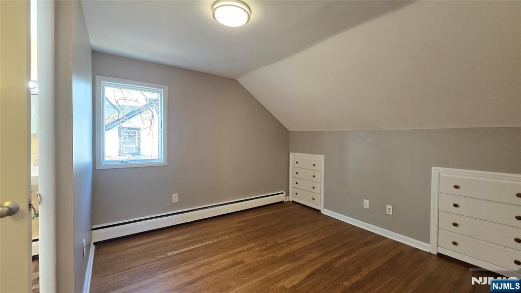 2-72 Saddle River Road Fair Lawn, NJ 07410 - Photo 20 of 33 an empty room with wooden floor cabinet and windows
