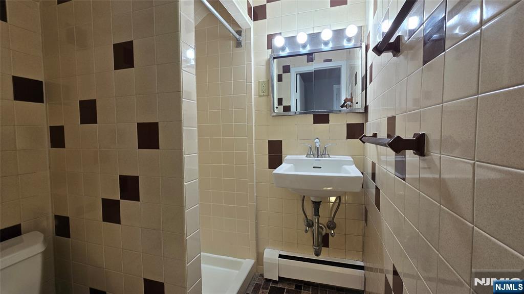 2-72 Saddle River Road Fair Lawn, NJ 07410 - Photo 21 of 33 a bathroom with a sink a mirror and shower