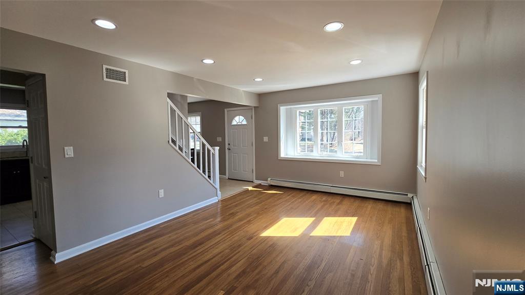 2-72 Saddle River Road Fair Lawn, NJ 07410 - Photo 3 of 33 wooden floor in an empty room with a window