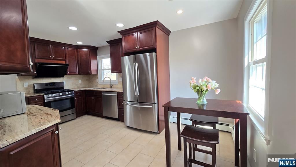 2-72 Saddle River Road Fair Lawn, NJ 07410 - Photo 6 of 33 a kitchen with granite countertop stainless steel appliances and a refrigerator