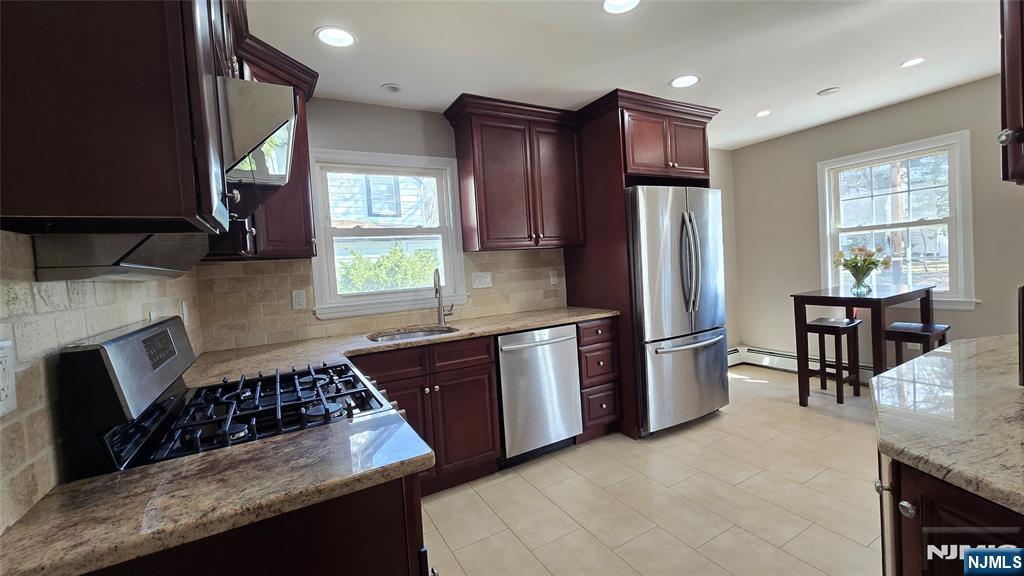 2-72 Saddle River Road Fair Lawn, NJ 07410 - Photo 7 of 33 a kitchen with stainless steel appliances granite countertop a stove refrigerator sink and cabinets