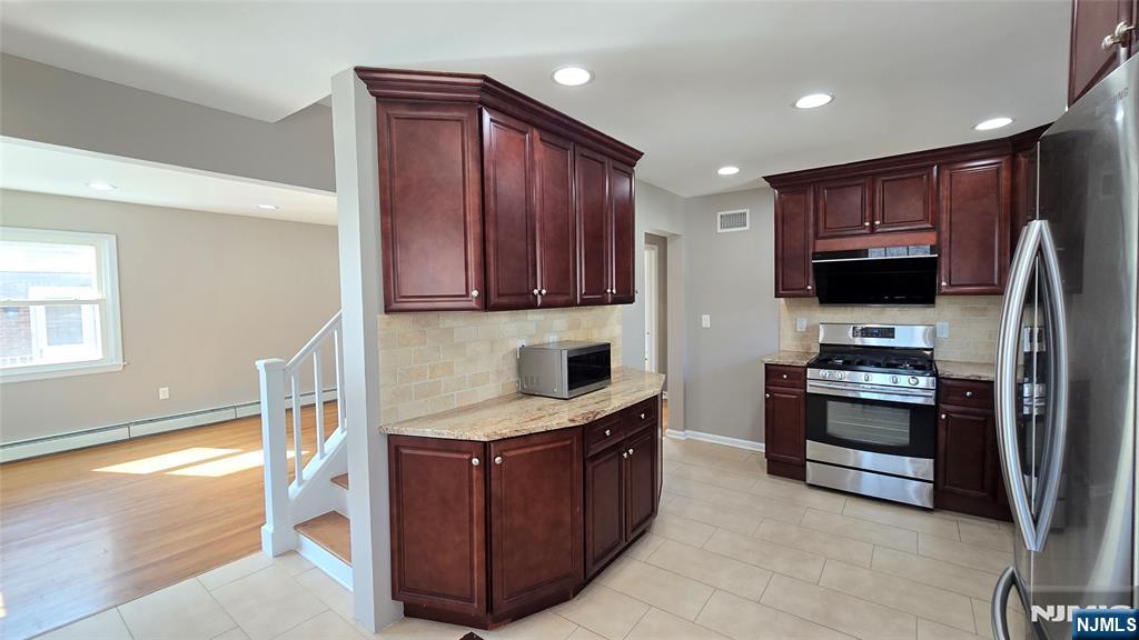 2-72 Saddle River Road Fair Lawn, NJ 07410 - Photo 8 of 33 a kitchen with stainless steel appliances granite countertop a stove a sink and a refrigerator