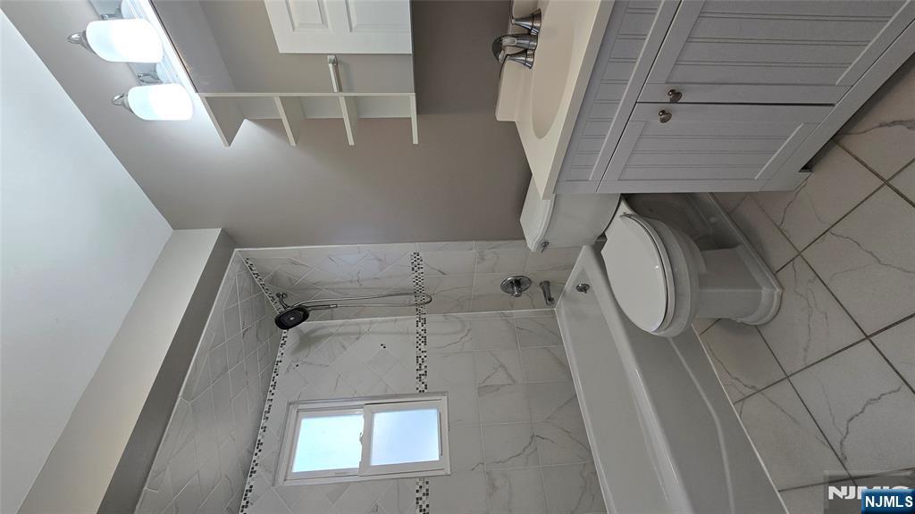 2-72 Saddle River Road Fair Lawn, NJ 07410 - Photo 9 of 33 a bathroom with a sink toilet and shower