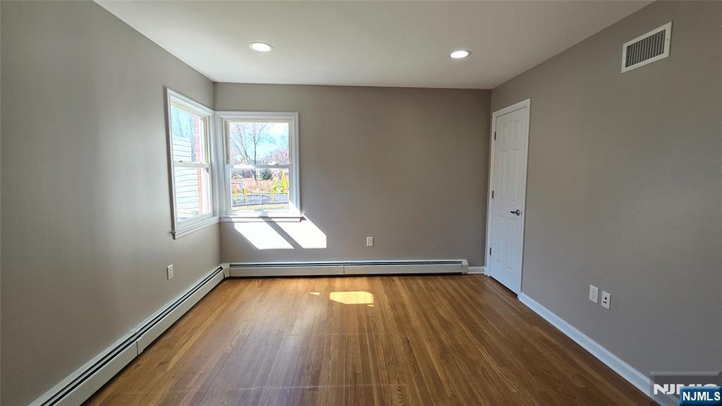 2-72 Saddle River Road Fair Lawn, NJ 07410 - Photo 10 of 33 a view of empty room with wooden floor and fan