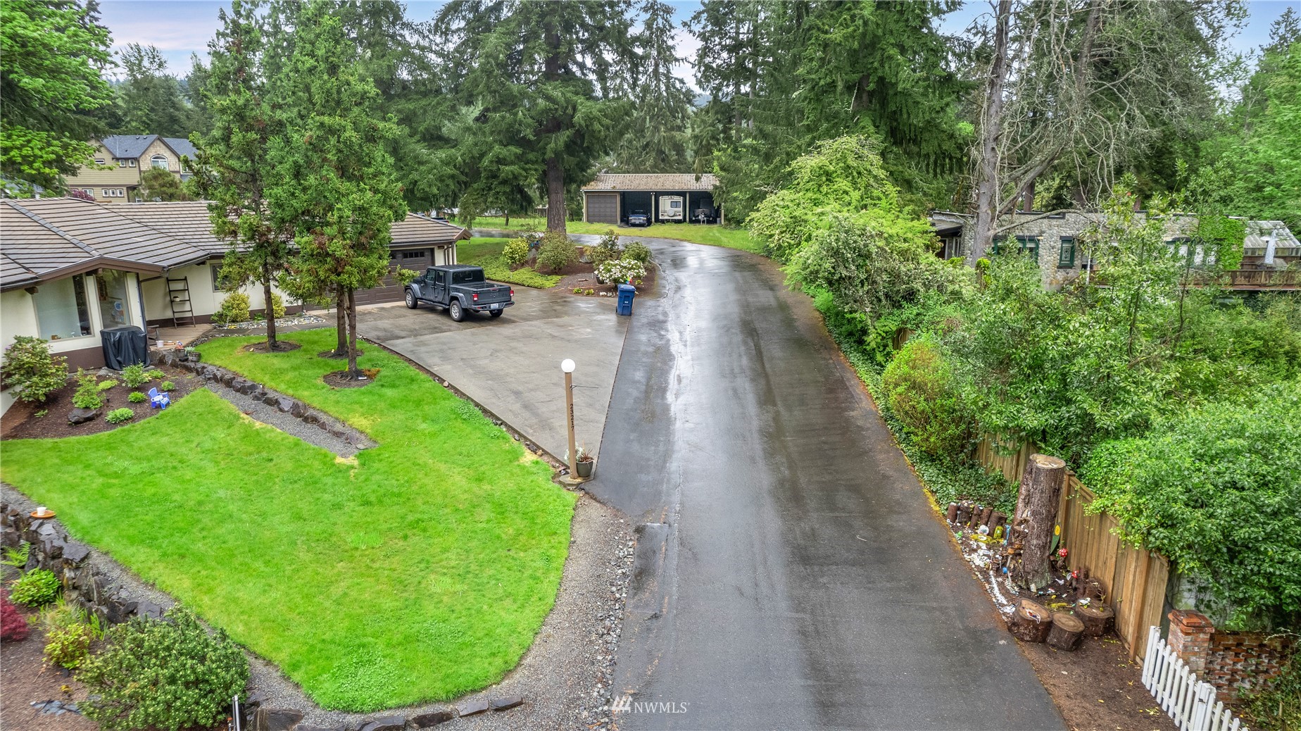 23231 Locust Way Bothell, WA 98021 - Photo 19 of 21 a view of a backyard with table and chairs potted plants and large tree