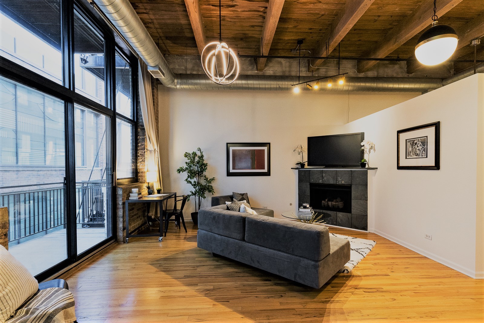 215 North Aberdeen Street, Unit 502B Chicago, IL 60607 - Photo 5 of 12 a living room with furniture and a fireplace