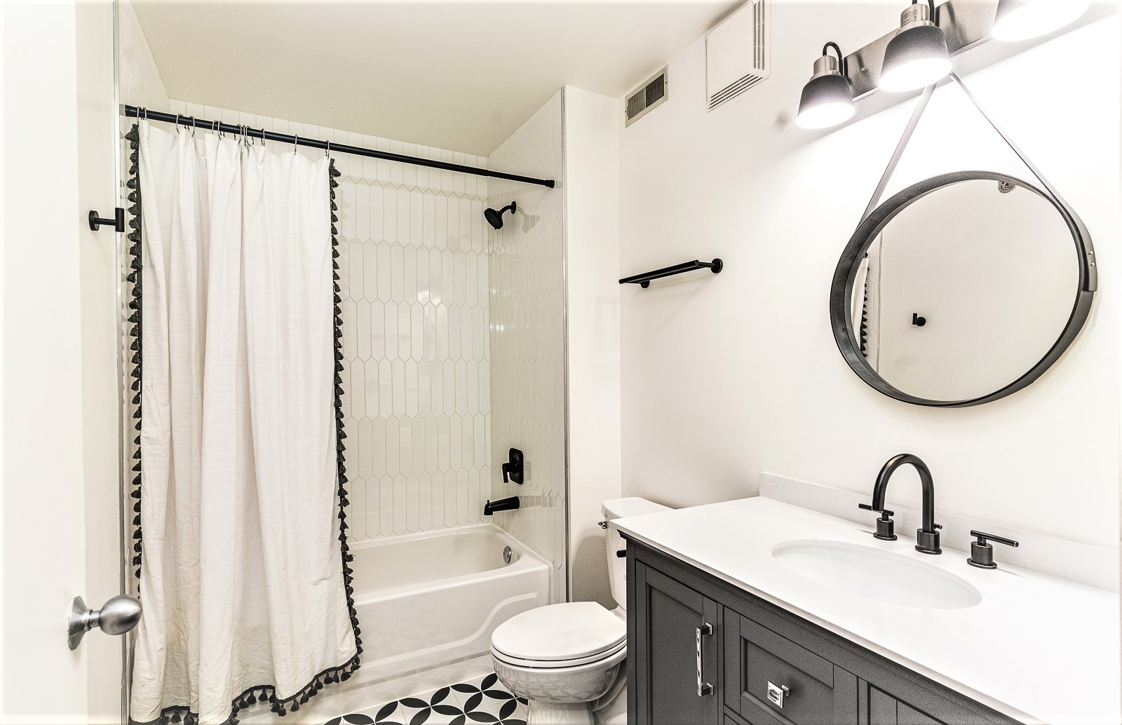 215 North Aberdeen Street, Unit 502B Chicago, IL 60607 - Photo 10 of 12 a bathroom with a sink a toilet and a mirror