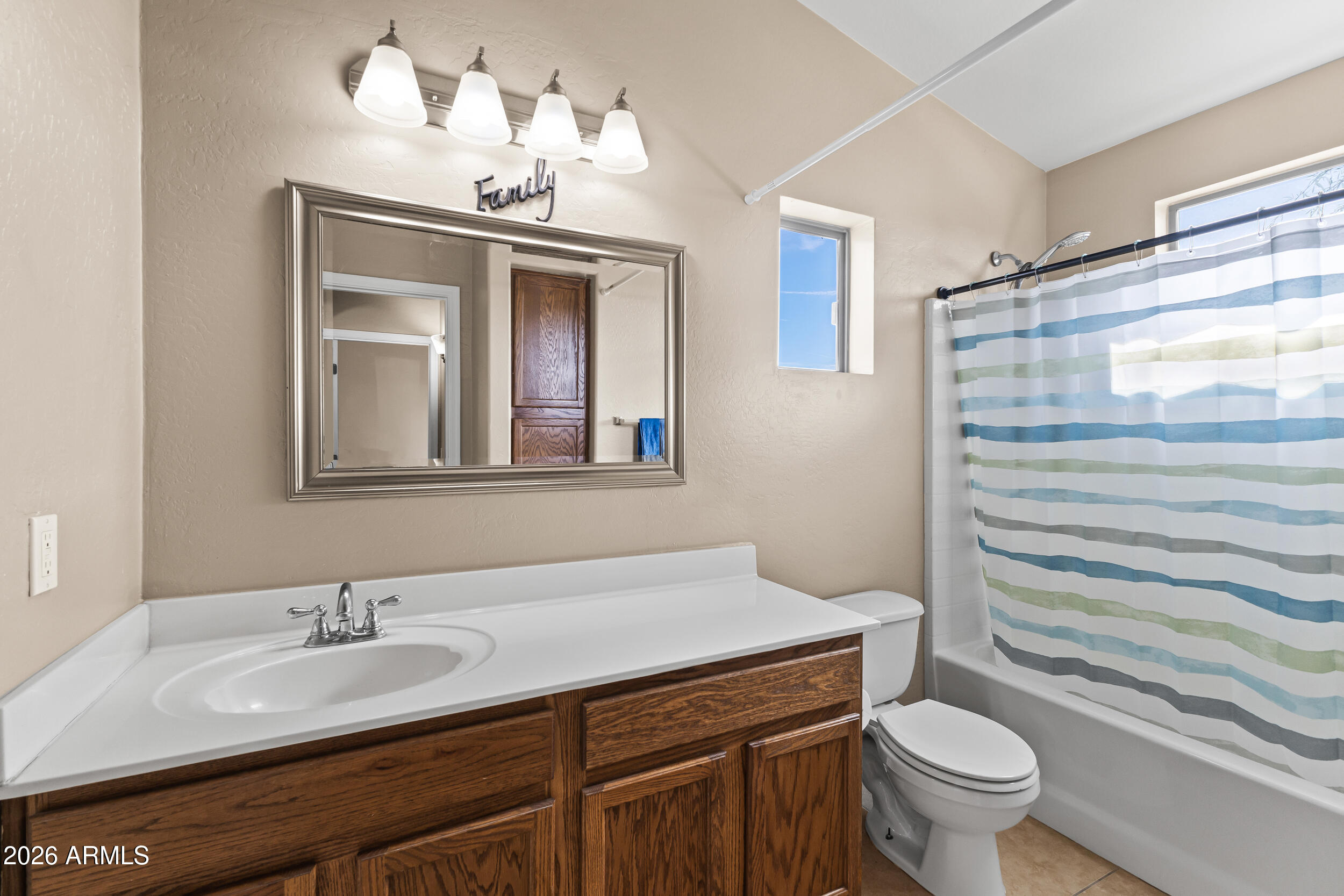 2150 East Bell Road, Unit 1140 Phoenix, AZ 85022 - Photo 13 of 21 a bathroom with a sink a toilet and a mirror