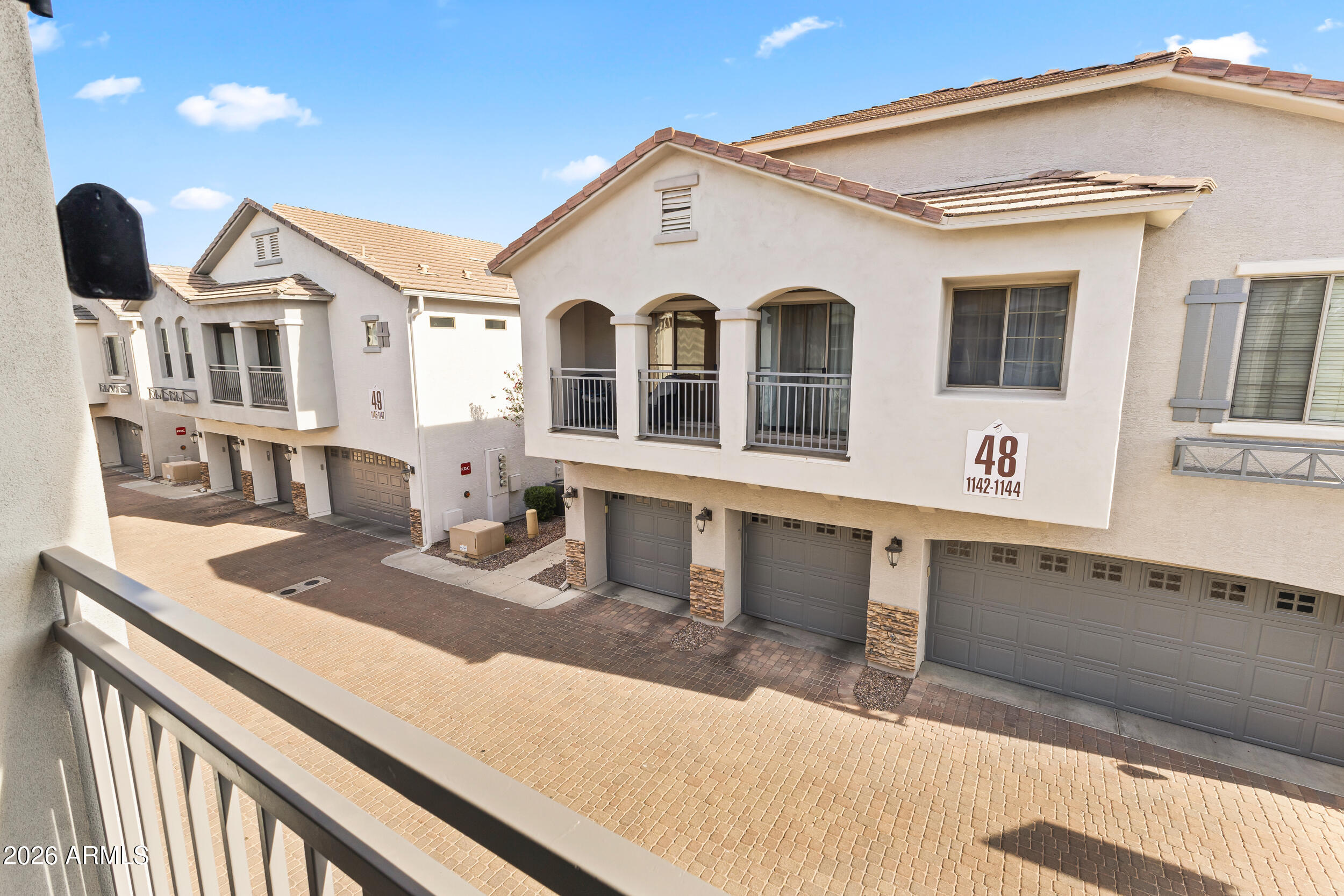 2150 East Bell Road, Unit 1140 Phoenix, AZ 85022 - Photo 14 of 21 a view of a white house with large windows and a sink