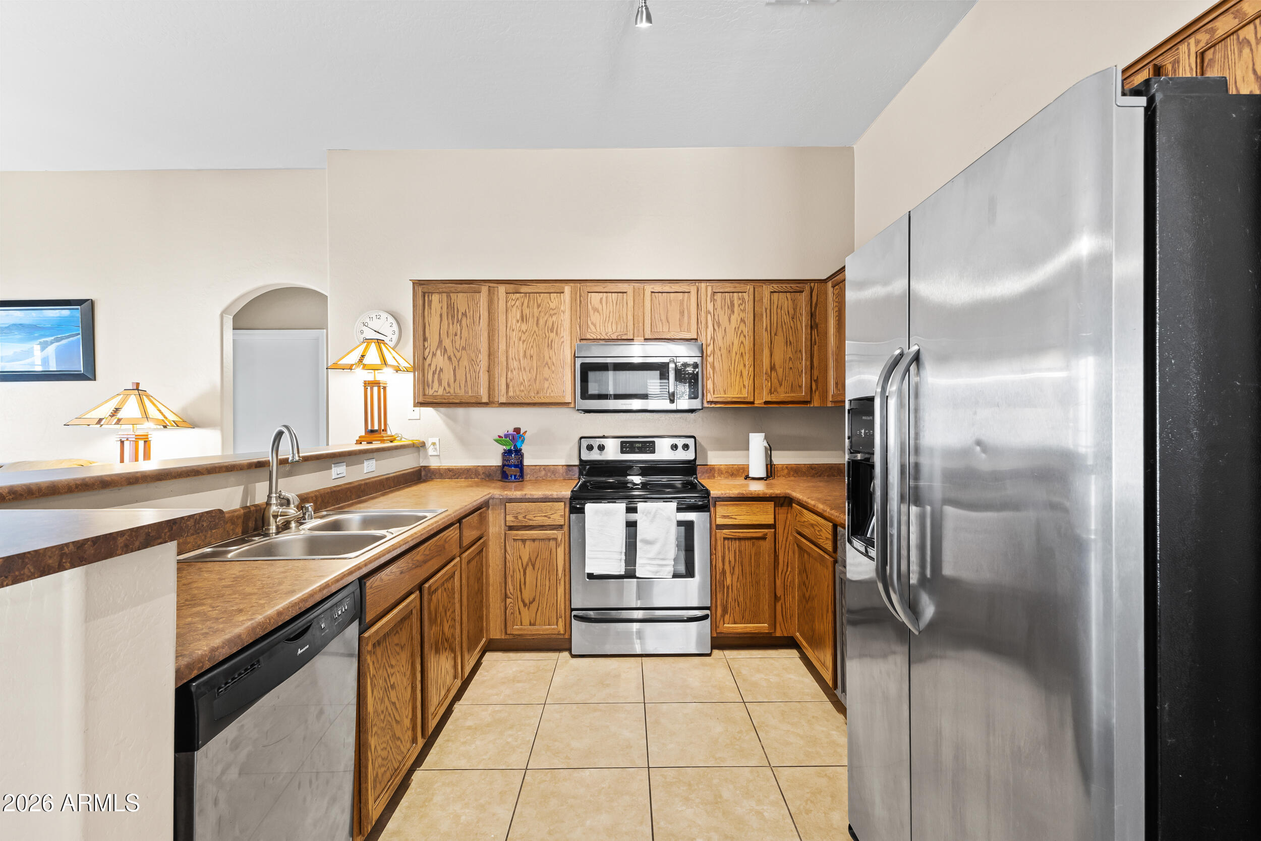 2150 East Bell Road, Unit 1140 Phoenix, AZ 85022 - Photo 3 of 21 a kitchen with stainless steel appliances granite countertop a refrigerator and a stove top oven