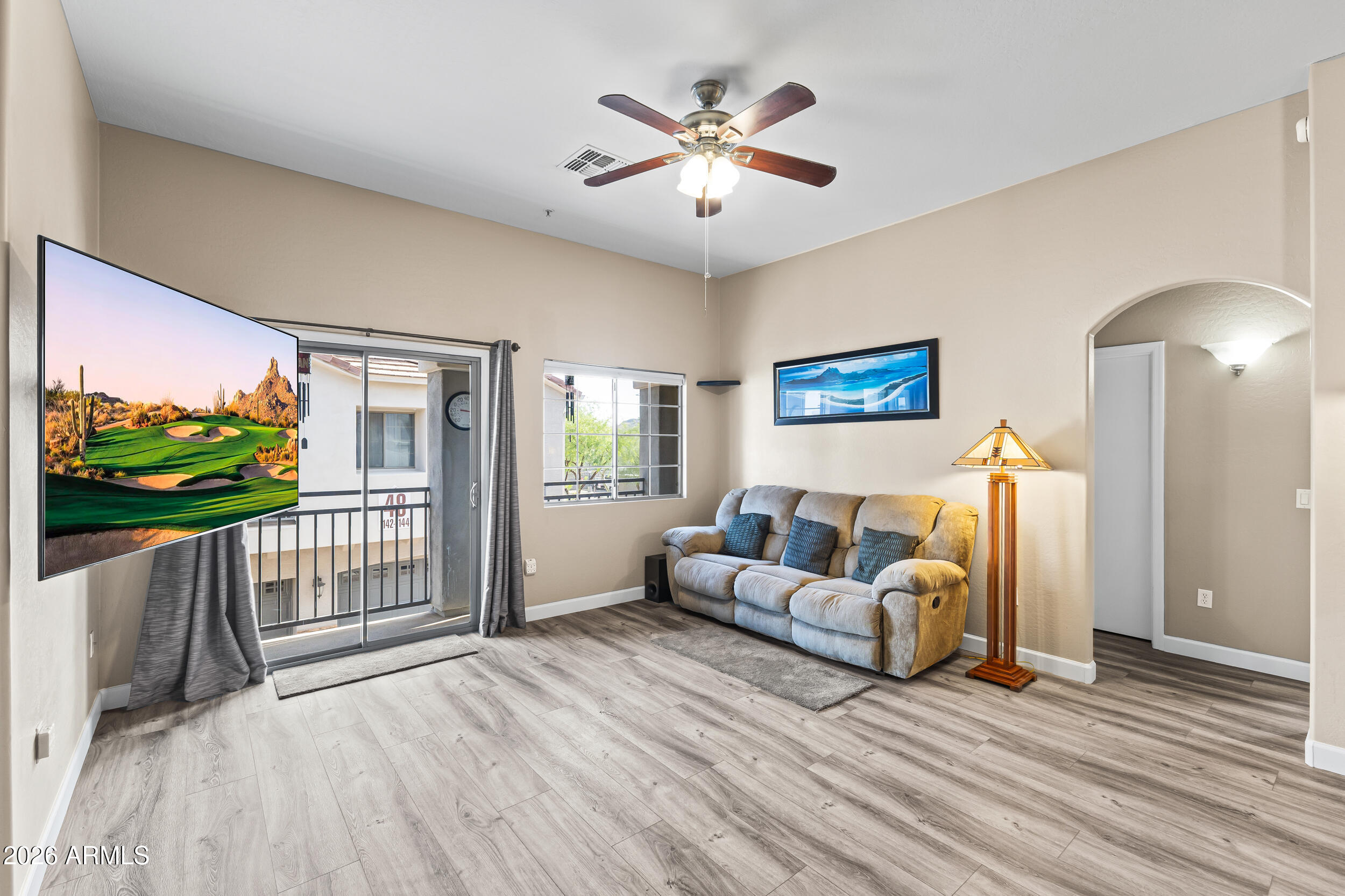 2150 East Bell Road, Unit 1140 Phoenix, AZ 85022 - Photo 4 of 21 a living room with furniture garden view and a flat screen tv