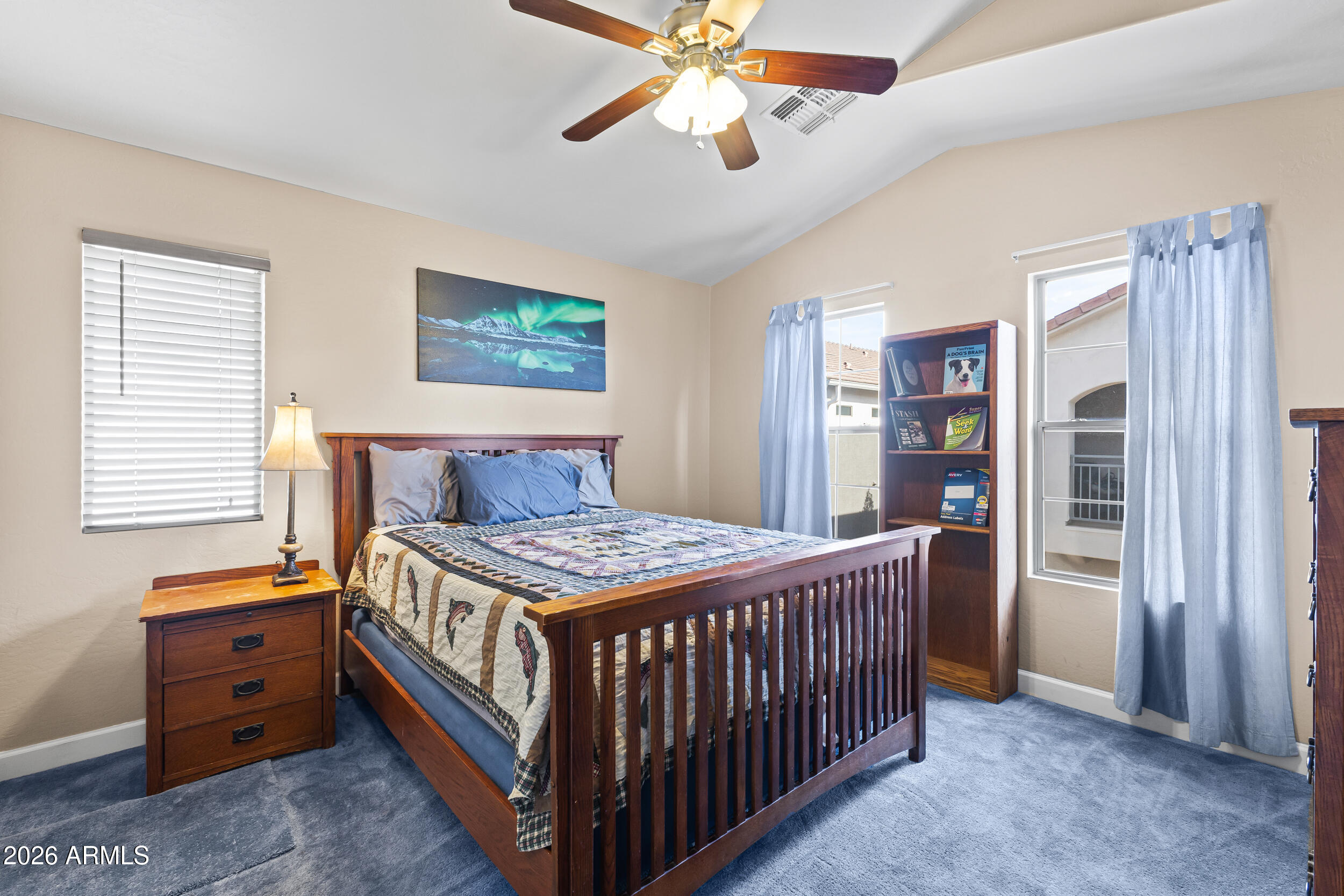 2150 East Bell Road, Unit 1140 Phoenix, AZ 85022 - Photo 7 of 21 a bedroom with a bed and a chandelier
