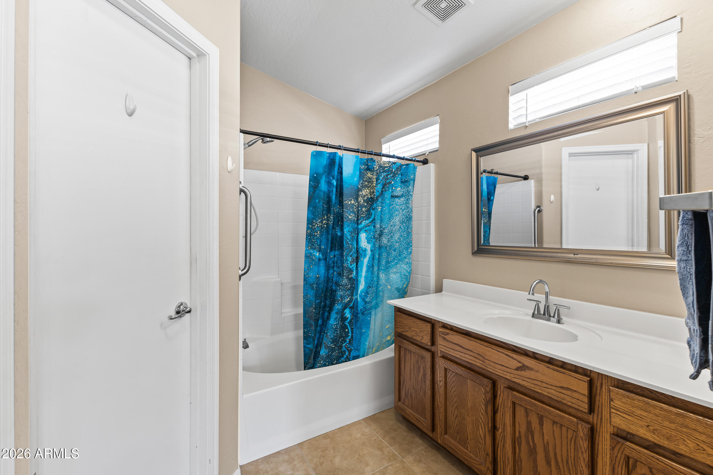 2150 East Bell Road, Unit 1140 Phoenix, AZ 85022 - Photo 8 of 21 a bathroom with a double vanity sink a mirror and a bathtub
