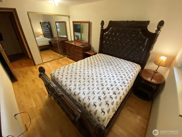 a bed sitting in a bedroom next to a window