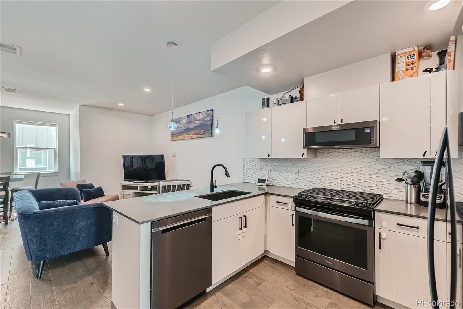 1284 Stuart Street Denver, CO 80204 - Photo 13 of 43 a kitchen with a sink stove top oven and microwave