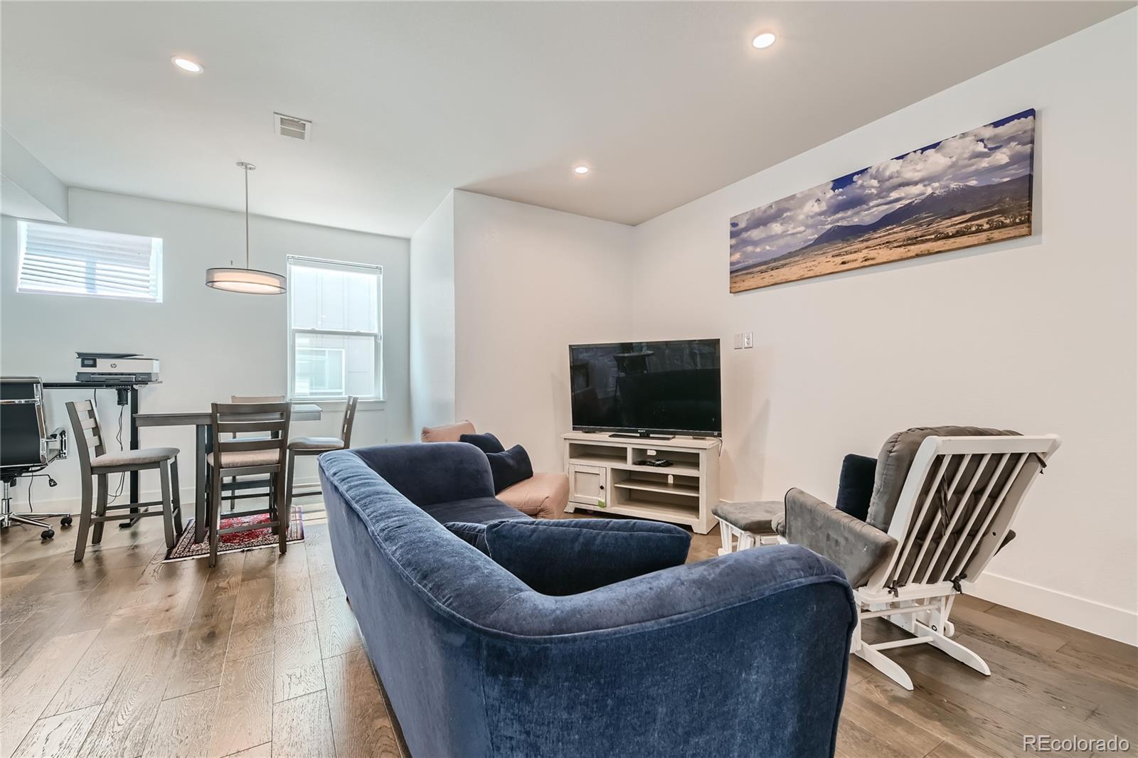1284 Stuart Street Denver, CO 80204 - Photo 16 of 43 a living room with furniture and a flat screen tv
