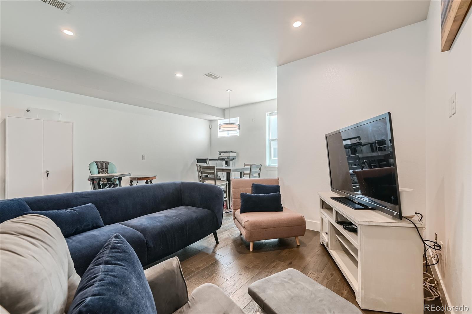 1284 Stuart Street Denver, CO 80204 - Photo 17 of 43 a living room with furniture and a flat screen tv
