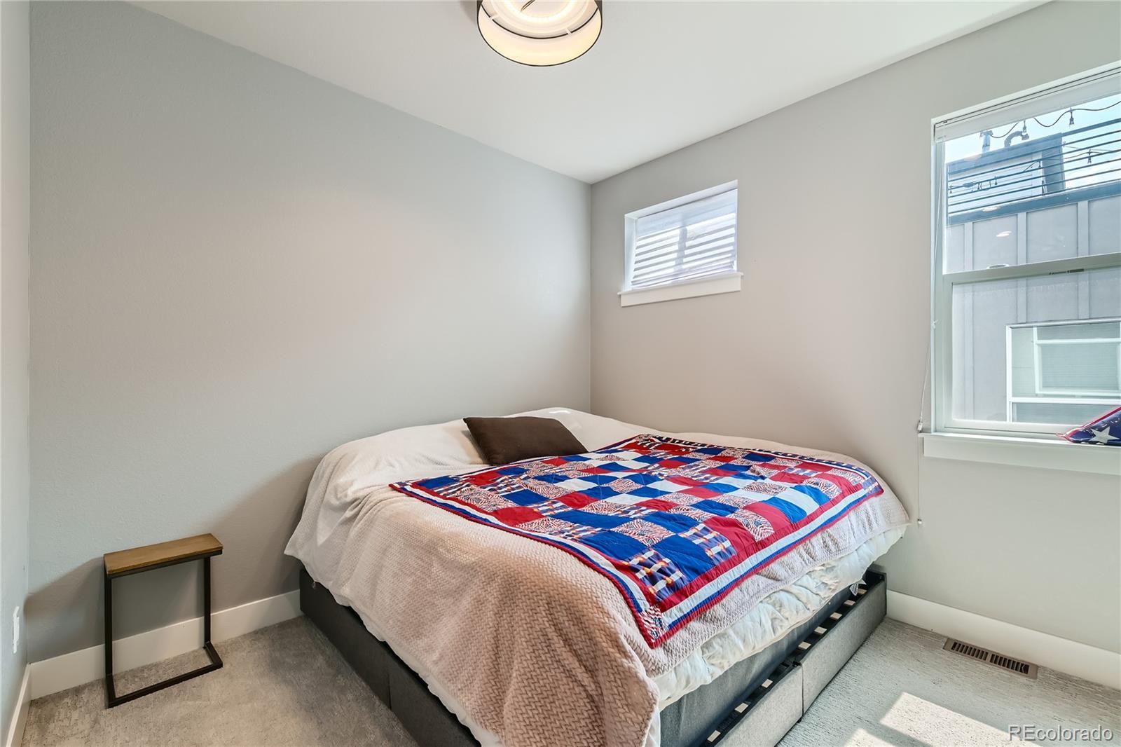 1284 Stuart Street Denver, CO 80204 - Photo 20 of 43 a bedroom with a bed and a window