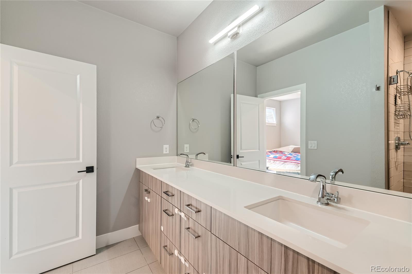 1284 Stuart Street Denver, CO 80204 - Photo 23 of 43 a bathroom with a double vanity sink mirror and double