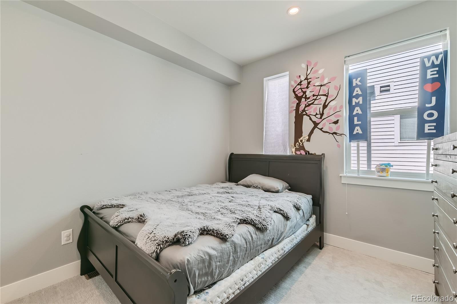 1284 Stuart Street Denver, CO 80204 - Photo 24 of 43 a bedroom with a bed and a window