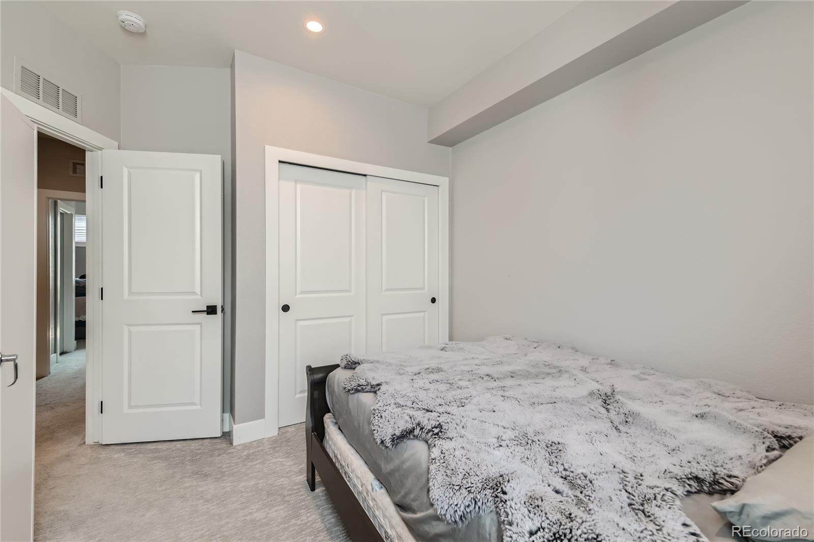 1284 Stuart Street Denver, CO 80204 - Photo 25 of 43 a bedroom with a bed and a window