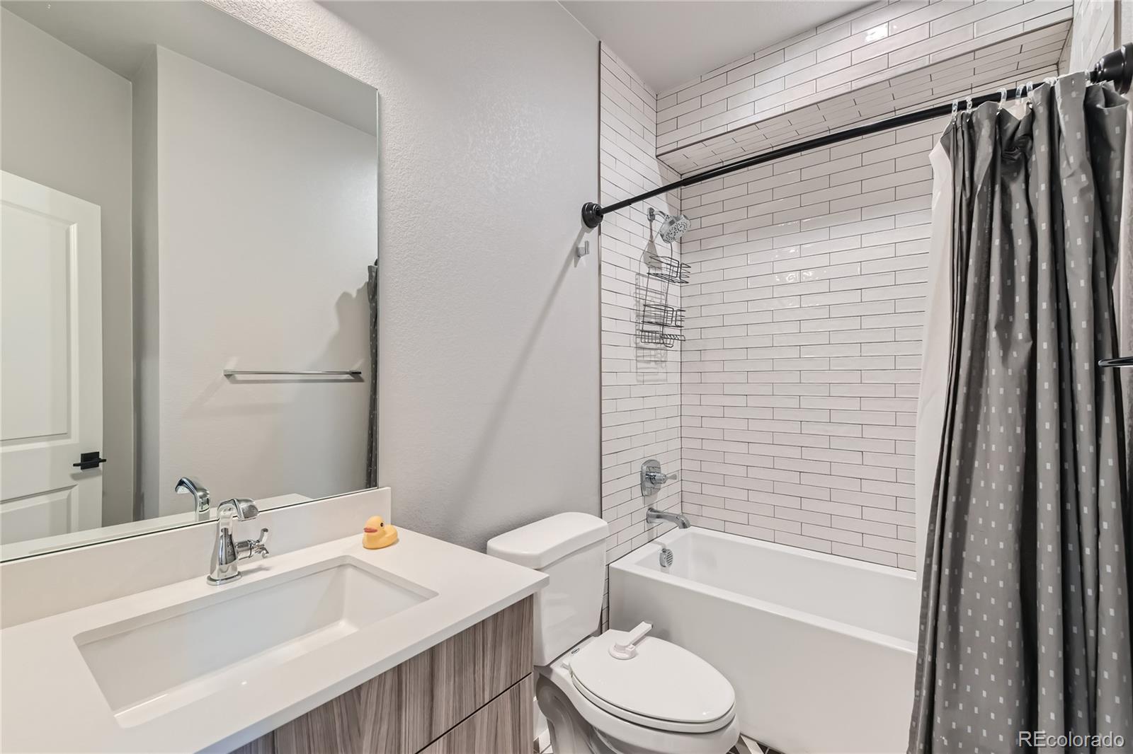 1284 Stuart Street Denver, CO 80204 - Photo 26 of 43 a bathroom with a sink toilet and shower