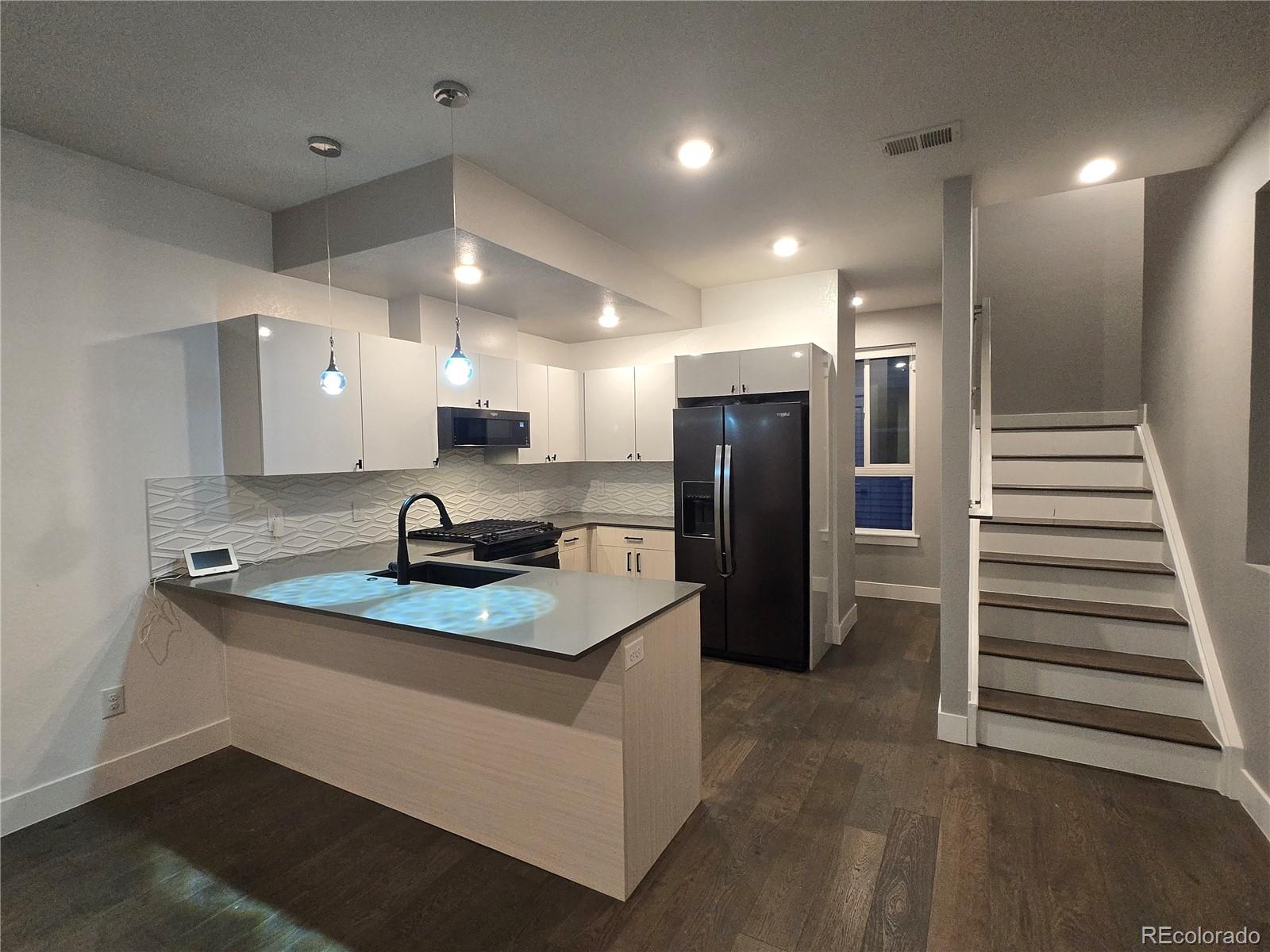1284 Stuart Street Denver, CO 80204 - Photo 10 of 43 a kitchen with stainless steel appliances granite countertop a refrigerator a sink and a stove