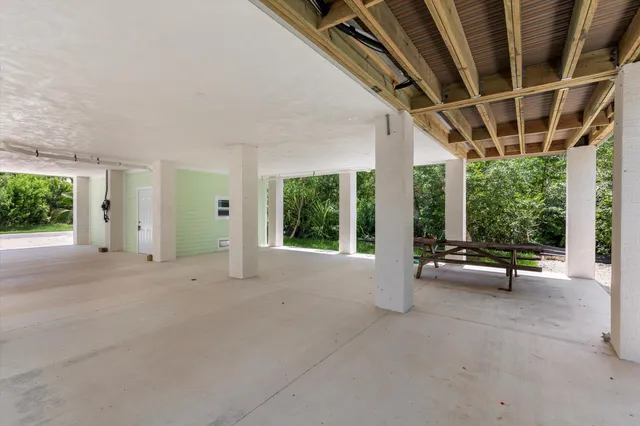a view of backyard with wooden fence and a large tree