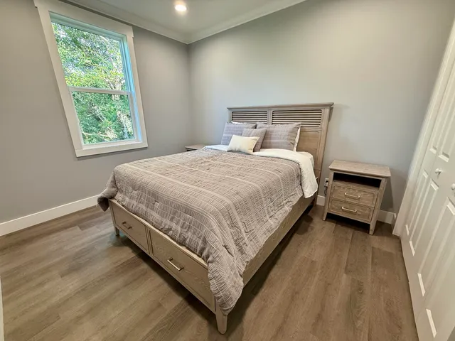 a bed sitting in a bedroom next to a window