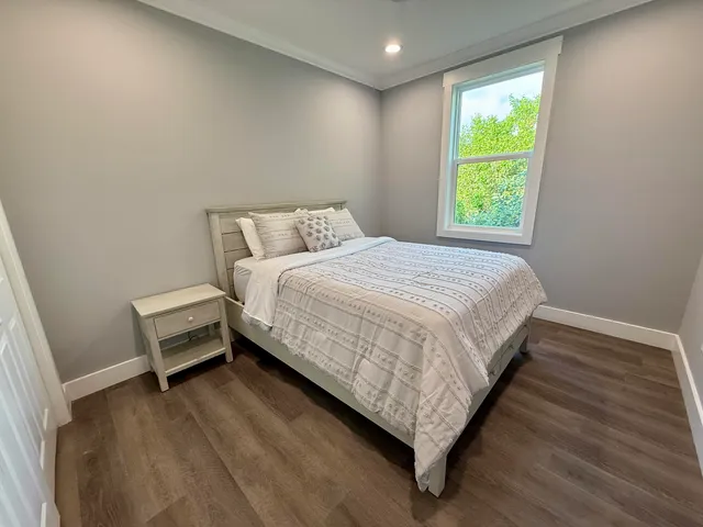 a bedroom with a bed and a window