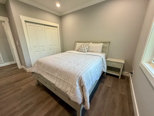 a bed sitting in a bedroom next to a window