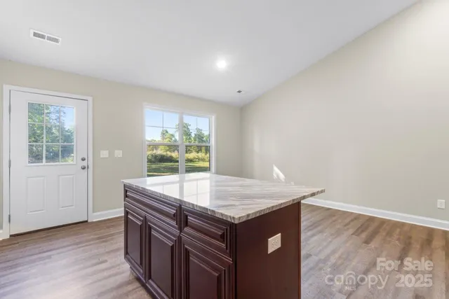 a room with a wooden floor and a sink