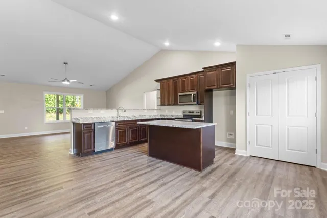 a large kitchen with a large counter top appliances and cabinets