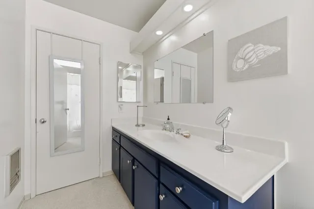 a bathroom with a sink a mirror and a shower