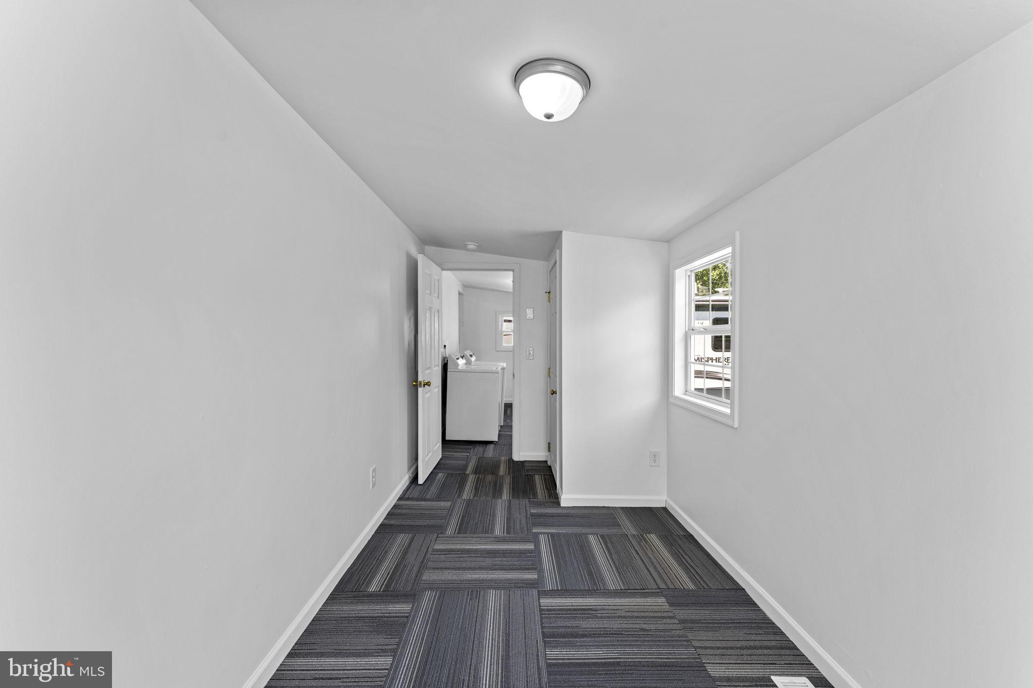 216 Walnut Street Berryville, VA 22611 - Photo 33 of 36 a view of a hallway with wooden floor and a bathroom