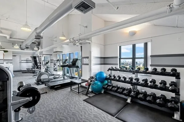 a bed room with lots of gym equipment