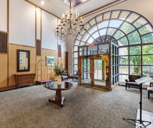a living room with couch and a chandelier