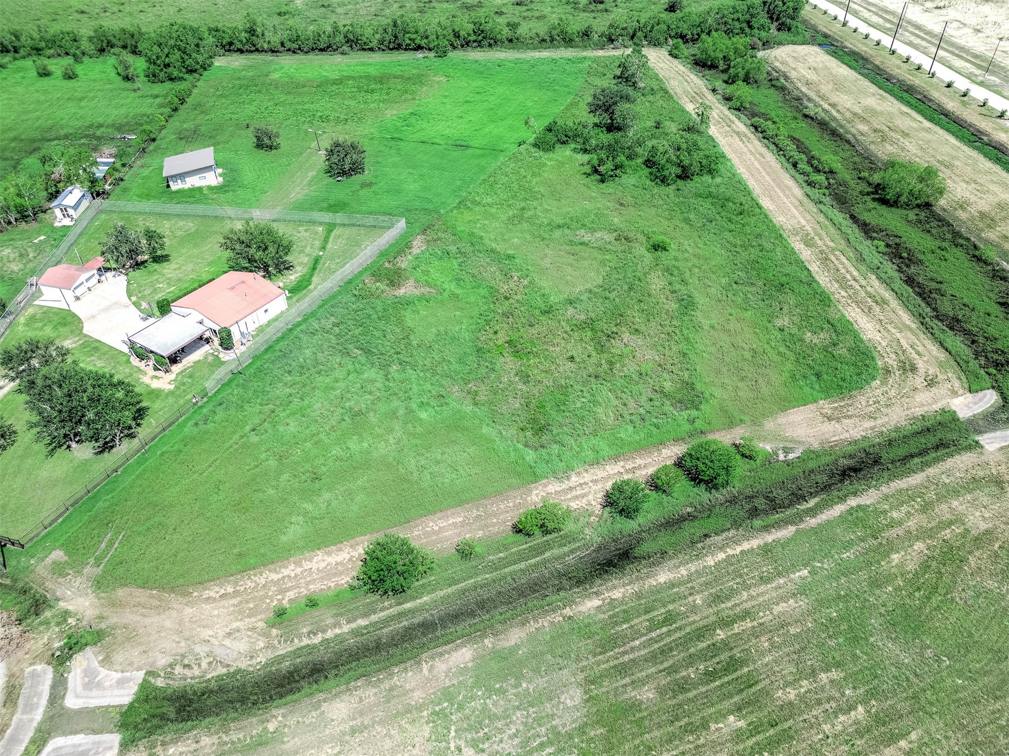 14411 Austin Bayou Drive Rosharon, TX 77583 - Photo 13 of 15 a view of a houses with grassy field and trees
